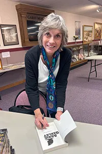 Shirl Kasper signing a copy of her book