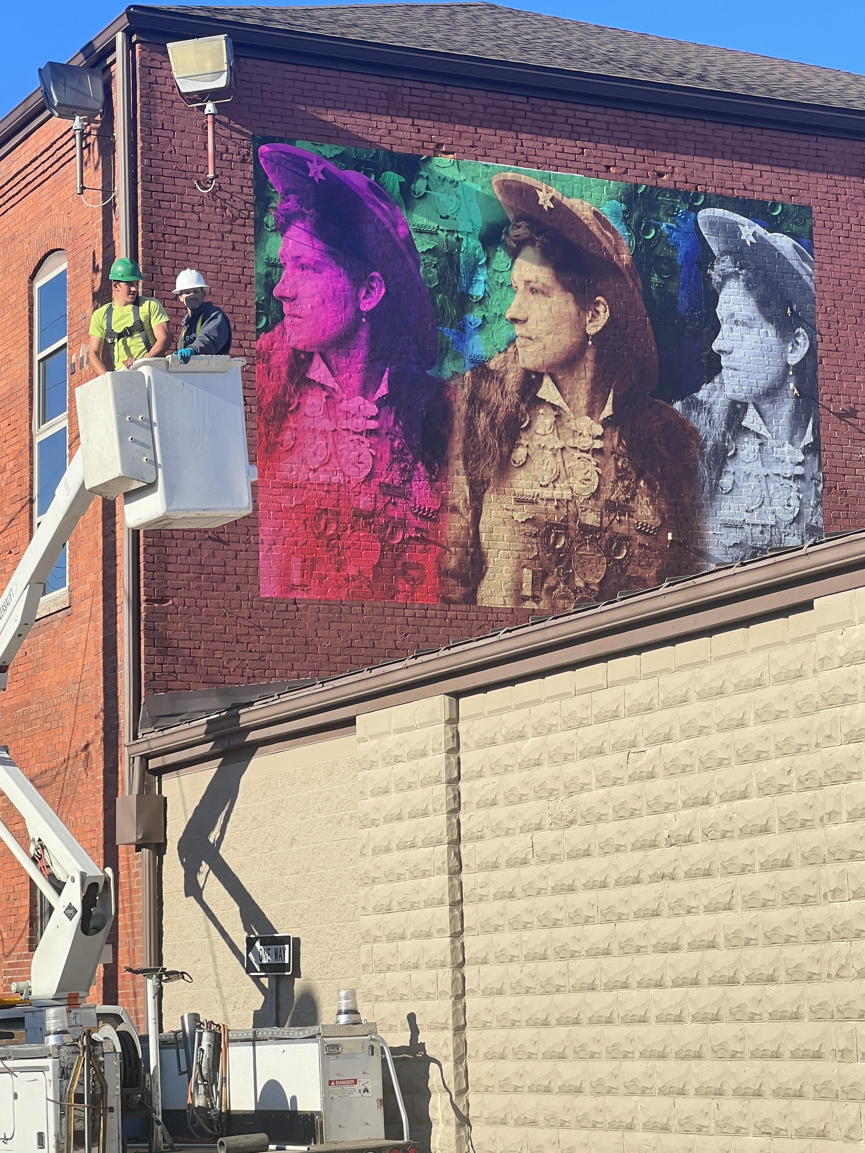 The Annie Oakley mural on the wall of Sure Shot Tap House